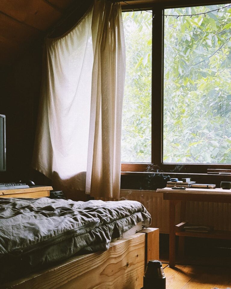 A serene cabin bedroom with natural light streaming through the window.