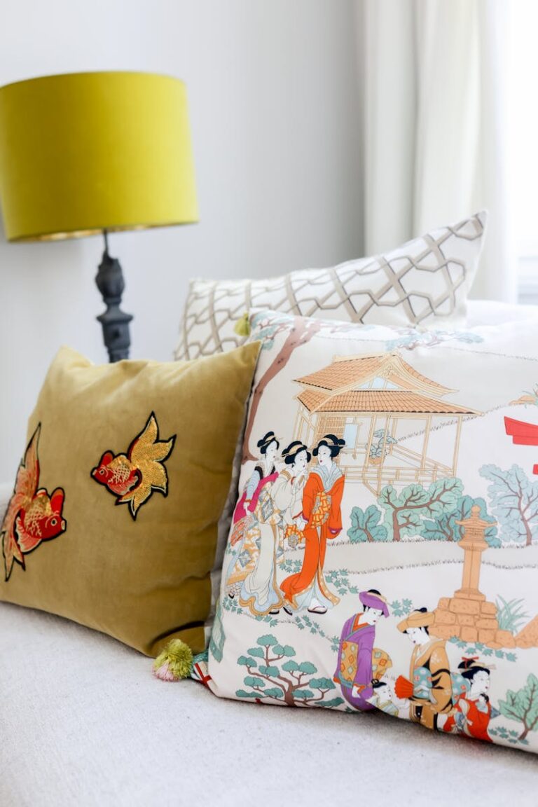 Stylish interior with art-inspired pillows on a cozy bed, perfect for modern aesthetics.